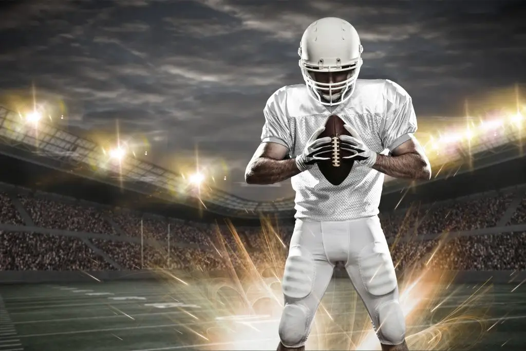 Football Player with a white uniform on a stadium.