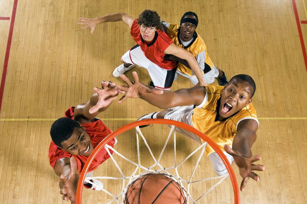 High angle view of basketball player dunking basketball in hoop